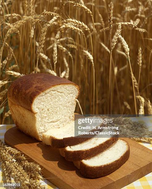 1980s LOAF OF BREAD 3 SLICES HARVEST WHEAT BACKGROUND