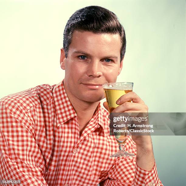 1960s MAN RED CHECKED SHIRT DRINKING BEER FROM PILSNER GLASS