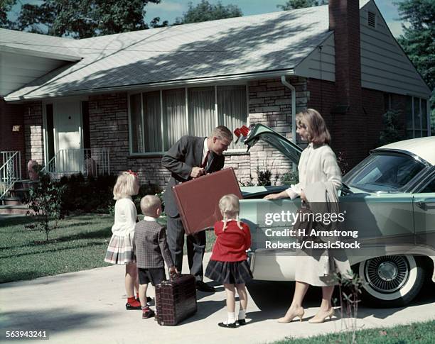 1960s SUBURBAN FAMILY LOADING FORD FOUR DOOR SEDAN AUTOMOBLE FOR TRIP NOSTALGIA OUTDOOR MAN WOMAN BOY GIRL