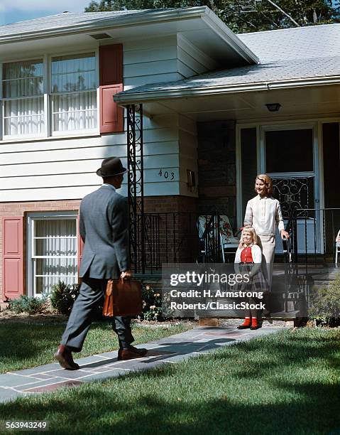 1950s MOTHER DAUGHTER WAITING STEP SUBURBAN HOUSE FATHER BRIEFCASE COMING HOME MAN WOMAN GIRL FAMILY