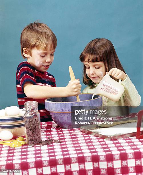 1970s BOY GIRL BROTHER SISTER MAKING COOKIES STIRRING BATTER CHOCOLATE CHIPS BAKING COOKING