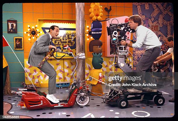 Publicity still from the children's television show 'Pee Wee's Playhouse' shows star Paul Reubens and cinematographer Daryl Studebaker, 1986.