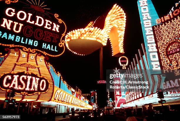 1970s MONTAGE OF NEON CASINO LIGHTS ON FREMONT STREET DOWNTOWN LAS VEGAS NEVADA AND THE FAMOUS GOLDEN SLIPPER SHOE