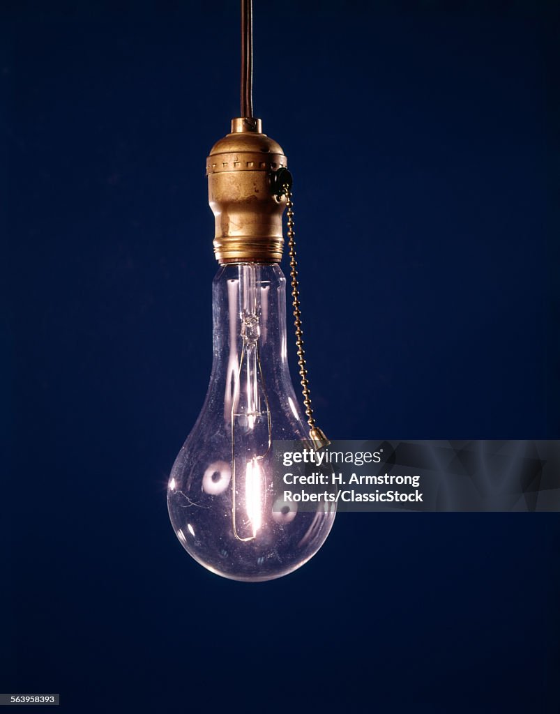 SINGLE BARE LIT LIGHT BULB...