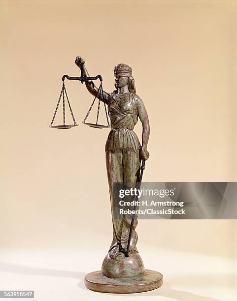 STATUE OF BLIND JUSTICE HOLDING SCALES SYMBOLIC OF LEGAL SYSTEM