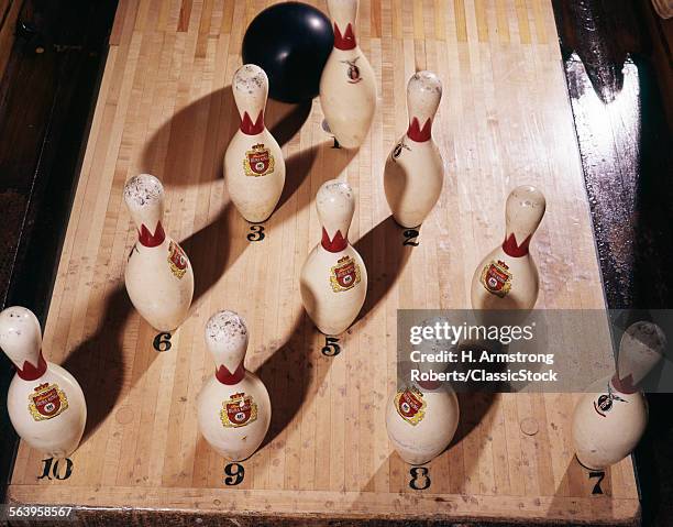 1960s BOWLING ALLEY VIEW FROM ABOVE BALL ABOUT TO HIT PINS TO SCORE A STRIKE