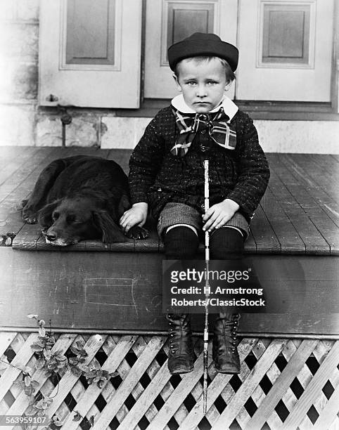 1800s 1890s 1900s TURN OF THE 20TH CENTURY SAD BOY HOLDING STICK SITTING ON PORCH NEXT TO DOG LOOKING AT THE CAMERA