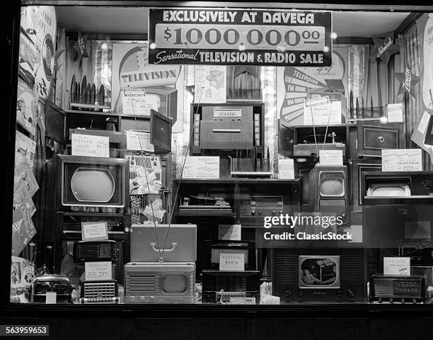 1940s WINDOW OF STORE SELLING RADIOS AND TELEVISIONS ADVERTISING A MILLION DOLLAR SALE