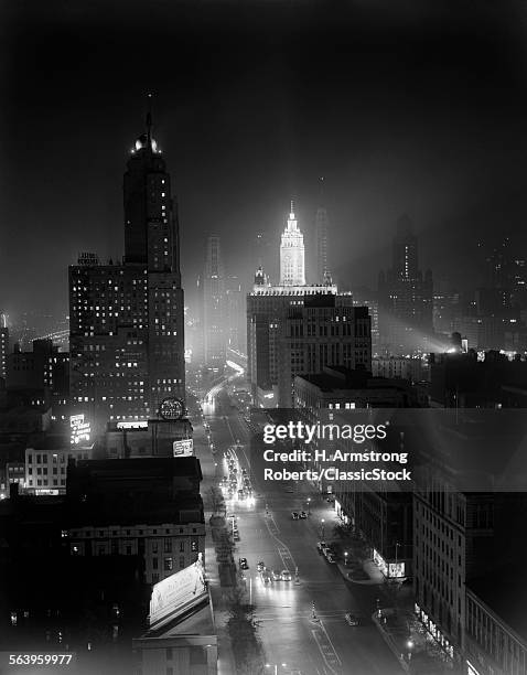 1950s NIGHT AERIAL CHICAGO ILLINOIS LOOKING DOWN ON MICHIGAN AVENUE