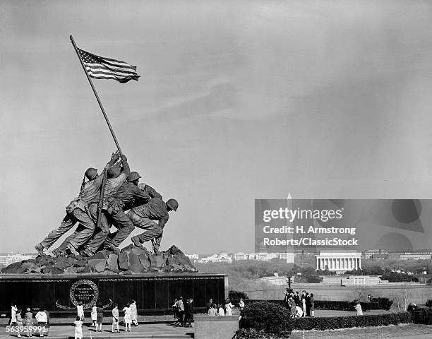 1960s MARINE CORPS MONUMENT IN ARLINGTON WITH WASHINGTON DC SKYLINE IN BACKGROUND