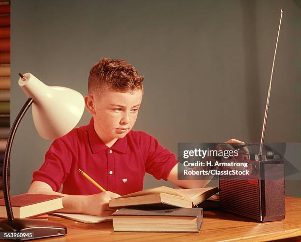 1960s BOY LISTENING RADIO STUDYING STUDY HOMEWORK BOYS LISTEN RADIOS BOOK BOOKS LAMP SCHOOL CHILDREN CHILD
