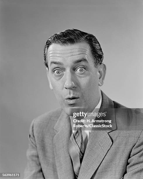 1960s BUSINESSMAN BULGING EYES WIDE OPEN SHOCKED FACIAL EXPRESSION LOOKING AT CAMERA