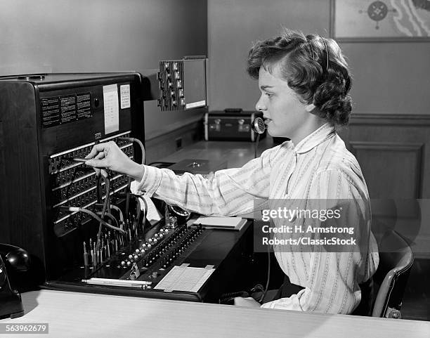 1950s WOMAN OFFICE TELEPHONE SWITCHBOARD RECEPTIONIST OPERATOR WEARING HEADSET ANSWERING TRANSFERRING CALL