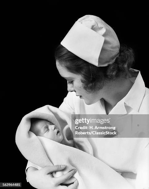 1940s 1930s NURSE HOLDING NEWBORN INFANT