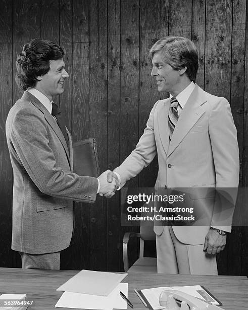 1970s 1980s TWO BUSINESSMEN SHAKING HANDS HANDSHAKE