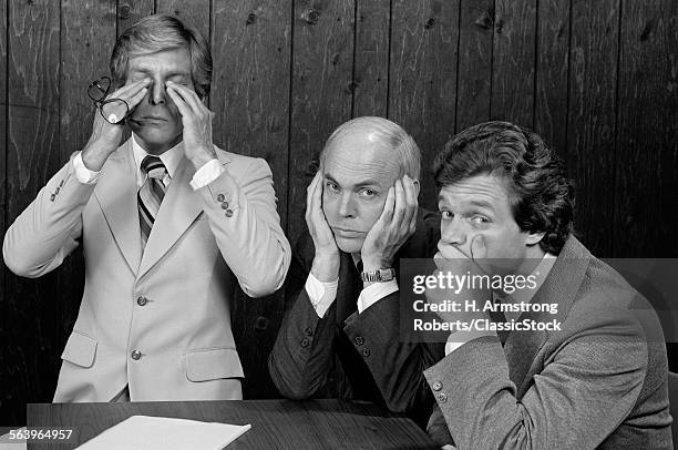 1970s COMMITTEE OF THREE BUSINESSMEN SYMBOLIC HAND GESTURES SEE NO EVIL HEAR NO EVIL SPEAK NO EVIL LOOKING AT CAMERA
