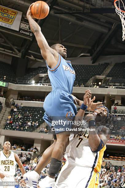 Gilbert Arenas of the Washington Wizards dunks over Jermaine O'Neal of the Indiana Pacers on December 8, 2005 at Conseco Fieldhouse in Indianapolis,...