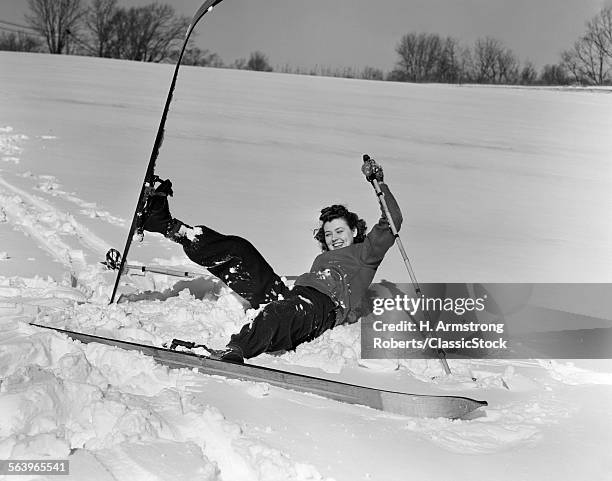 1940s 1930s WOMAN FALLING IN SNOW ON SKIS LAUGHING