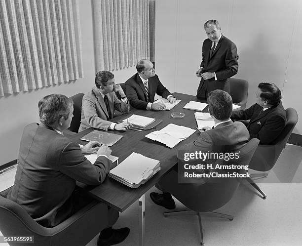 1960s 6 EXECUTIVE BUSINESSMEN AROUND CONFERENCE TABLE BOARD MEETING