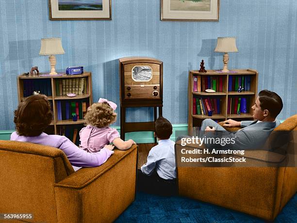 1940s 1950s FAMILY WATCHING TELEVISION IN LIVING ROOM