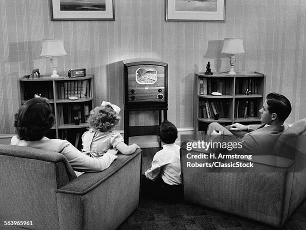 1940s 1950s FAMILY WATCHING TV IN LIVING ROOM