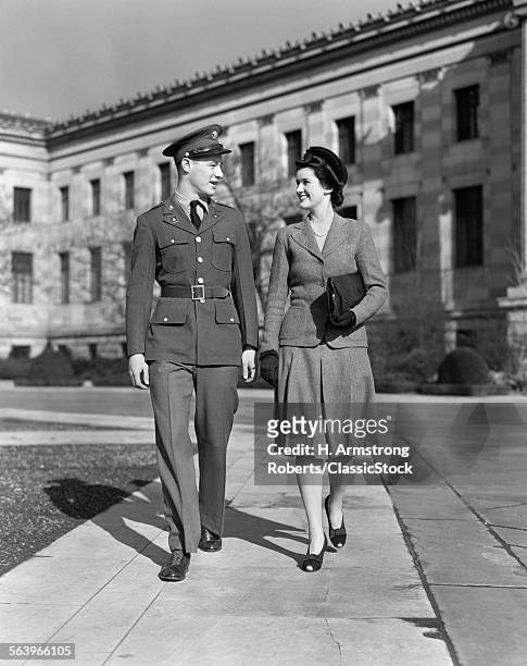 1940s SMILING COUPLE MAN WEARING ARMY UNIFORM WALKING TOGETHER