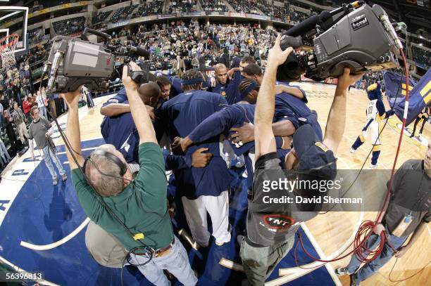 The Indiana Pacers huddle on the court near TNT TV cameramen prior to the tip off for the game against the Washington Wizards on December 8, 2005 at...