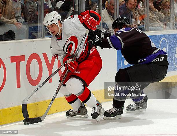 Chad LaRose of the Carolina Hurricanes skates around Tim Gleason of the Los Angeles Kings on December 8, 2005 at the Staples Center in Los Angeles,...