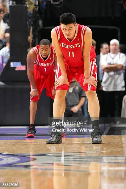 Tracy McGrady and Yao Ming of the Houston Rockets pause while on court during the game against the Sacramento King on December 8, 2005 at the ARCO...