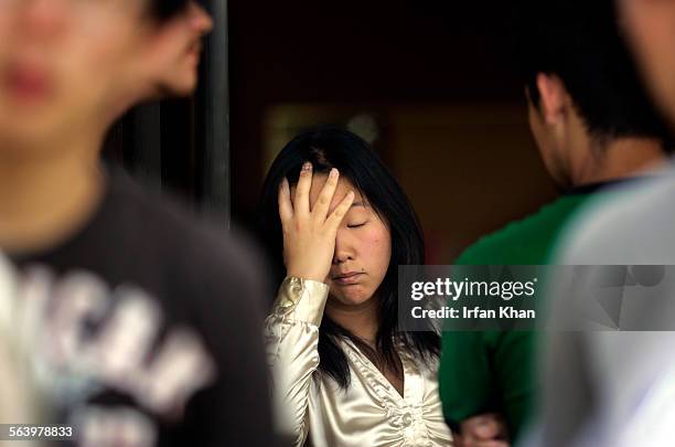 Pomona  Mar. 11, 2008.      Cherry Chon grieves at at Walnut Blessing Church of the Nazarene. Dead youn men were from this church. Authorities...