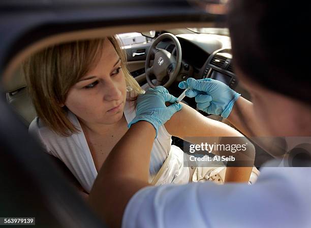 Moorpark CA. Motorists line up in their cars to get their flu shots the California way at the drive through. Stephanie Pierce, 16 years old gets her...