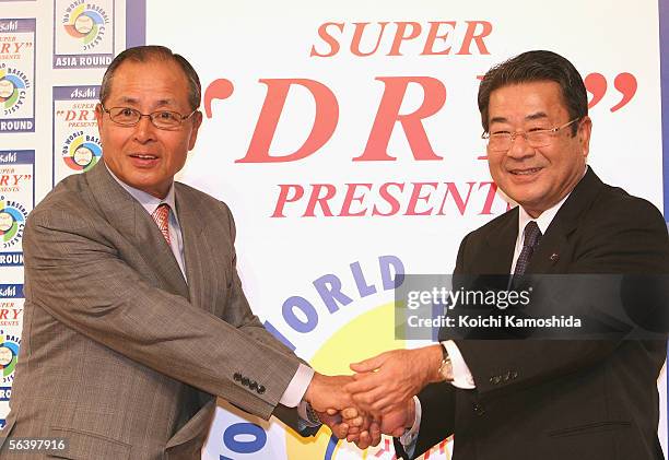 World Baseball Classic's Japanese team manager Sadaharu Oh and Kouichi Ikeda President & COO of Asahi Breweries Ltd, shake hands during the press...