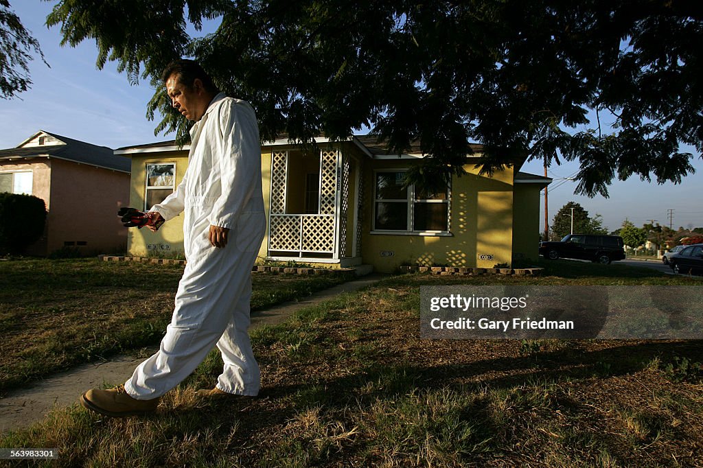Dwayne Hildalgo outside the foreclosed house in Norwalk that he and his dad, Ernest, purchased on 1