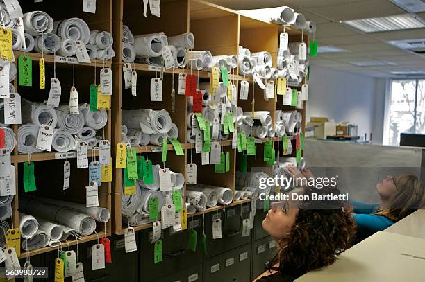 February 1, 2008. Newport Beach, CA. Permit technicians Jamie Harris, and Susan McCourt search for blueprints in a cramped passageway in the building...