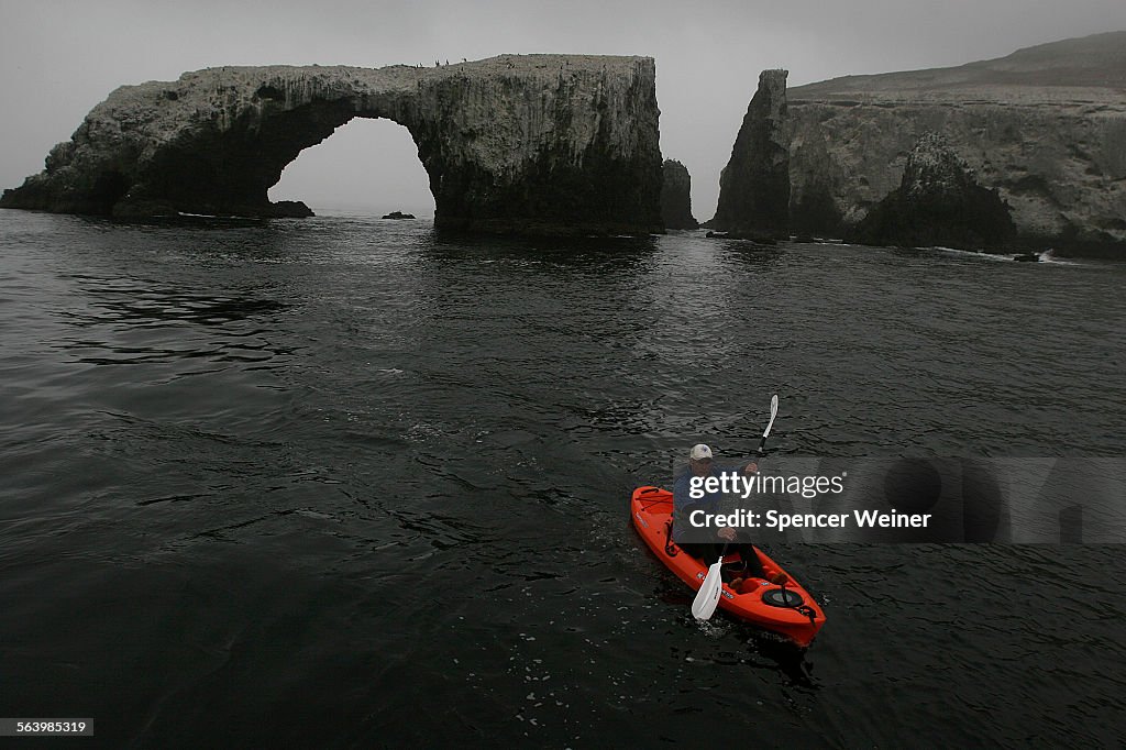 A kayaker navigates around Arch Rock on the east end of Anacapa Island, May 5, 2008. The forty foot