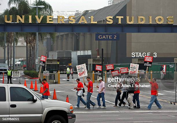 Writers Guild of America strikers picket outside Gate 2 of Universal Studios Tuesday morning, the second day of the strike in Universal City. Photos...