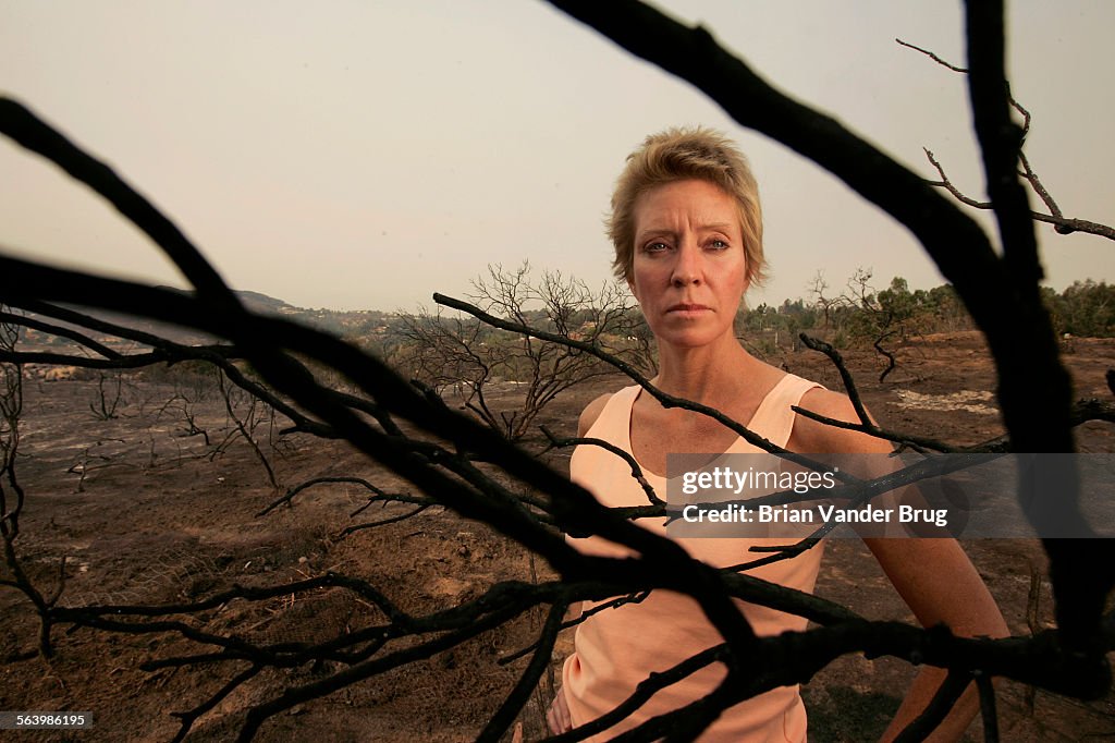 Amy Berling drenched a yard with a garden hose to protect a South Escondido home on Tuesday October