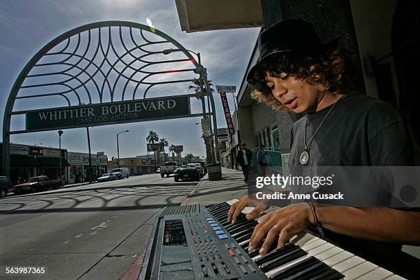 Esteban Flores a self taught musician, practices his keyboard as he waits for a bus on Whittier Boulevard in East Los Angeles May 14, 2008 near the...
