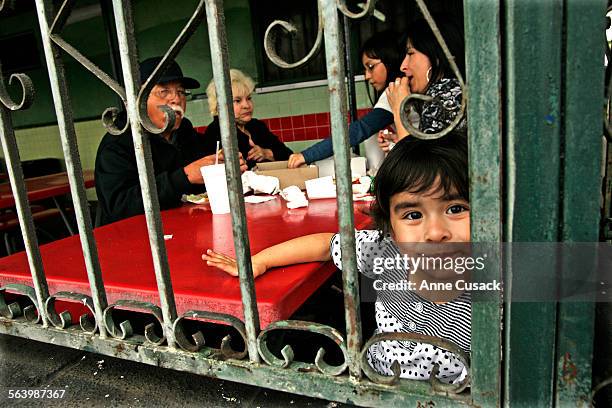 Sierra Uribe dines with her mother and grandparents at Chroni's a classic old food stand on Whittier Boulevard in East Los Angeles May 13, 2008....