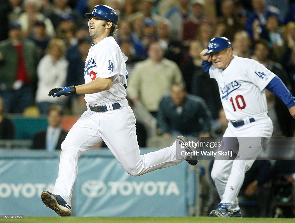 (Los Angeles, CA. 05062008) Dodgers Blake DeWitt sprints for home as 3rd base coach Larry Bowa ch