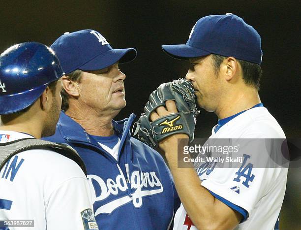 Dodgers pitcher Takashi Saito listens to pitching coach Rick Honeycutt after giving up a threerun home run in the 9th inning to Pirates batte Nate...