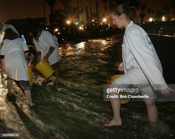 Cabrillo Marine research volunteer Michelle Kobal rushes to find grunion as she and volunteers helped Cabrillo Marine Aquarium biologists collect...