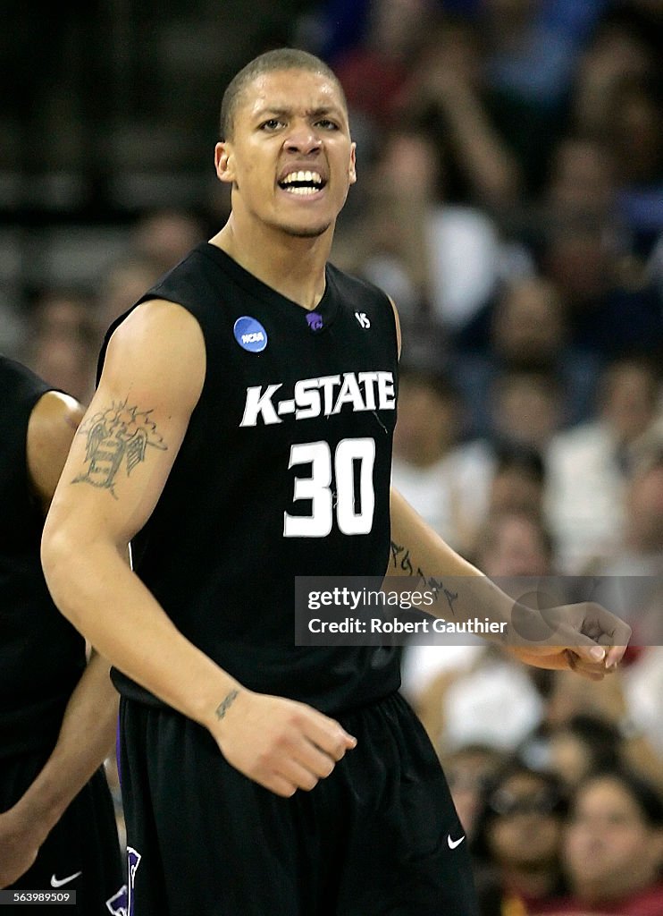 Kansas State Wildcats player Michael Beasley celebrates a basket against the USC Trojans in the fir