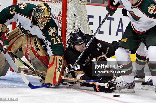 Minnesota Wild goalie Josh Harding uses the top part of his stick to keep the puck away from Ducks Corey Perry in the third period at Honda Center...
