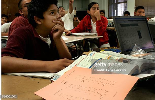 Jeff Melendez studies an overhead projection during his seventh grade math class on scientific notation at Virgil Middle School in Koreatown,...