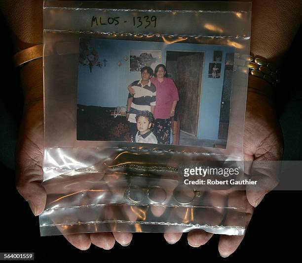 Cesareo Dominguez Saldivar of San Martin, Mexico holds the belongings found on the body of his daughter, Lucresia Dominguez Luna , who perished in...