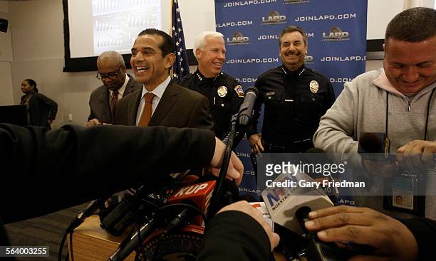 Los Angeles Mayor Antonio Villaraigosa and Los Angeles Police Chief Charlie Beck smiles as media members set up microphones during a press conference...