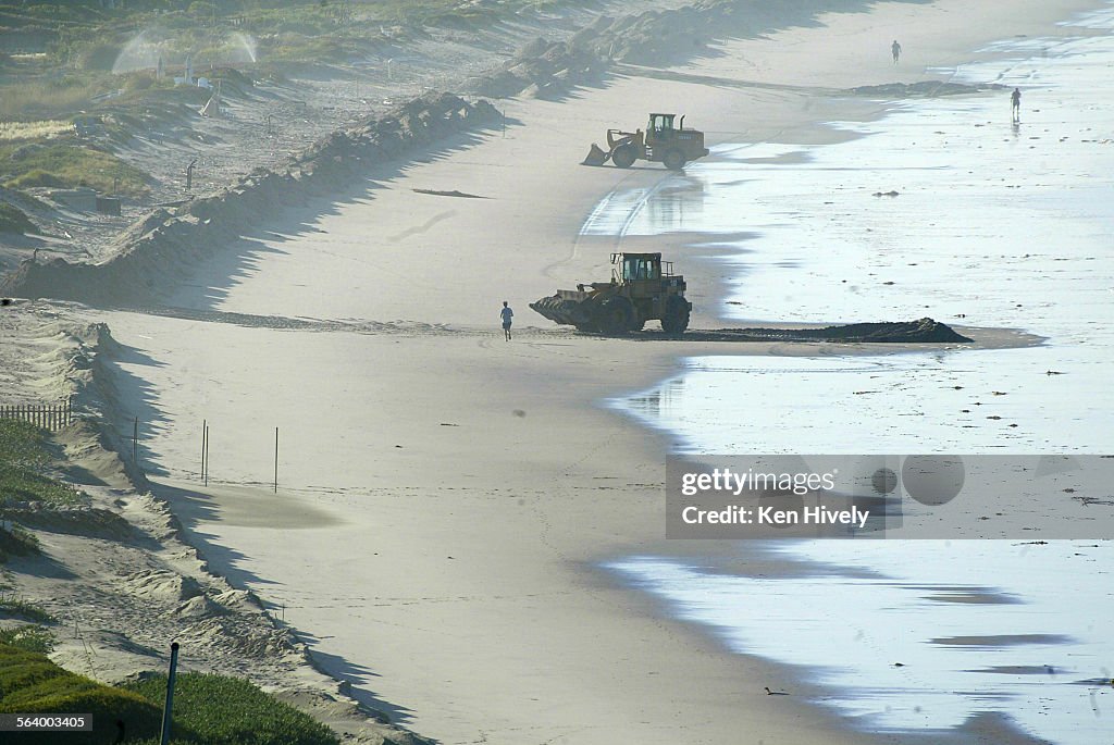 Two bulldozers on Broad Beach where the homeowners of Broad Beach, Malibu, infamous for notrespass