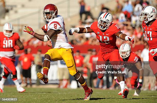 Recievr Marquise Lee breaks free after making a catch against Arizona's Wayne Capers Jr. And Derrick Rainey in the 3rd quarter in Tucson, Arizona...