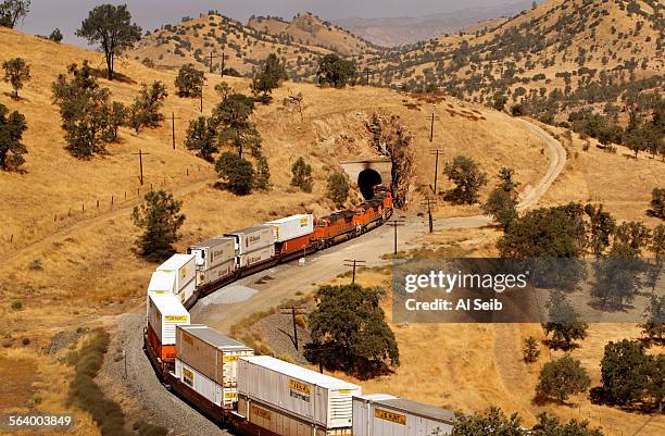 Freight train slowly descends westbound through Tehachapi Pass crossing the Tehachapi Mountains in Kern County, California on the Union Pacific line...